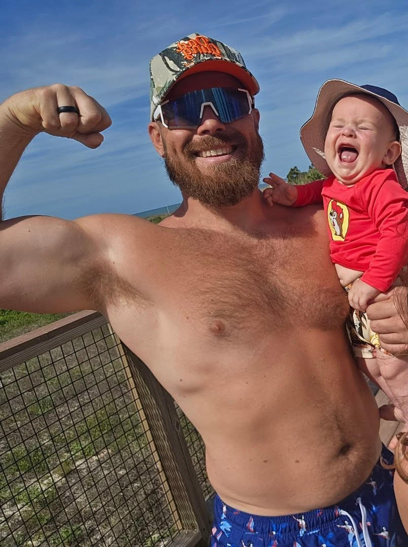 Lebanon dad flexing with his baby on Father's Day after training at Rise
